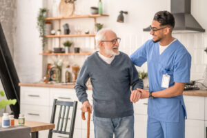 Medical worker helping his patient to move around the apartment