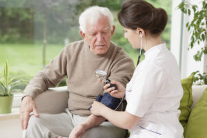 Young medic taking blood pressure