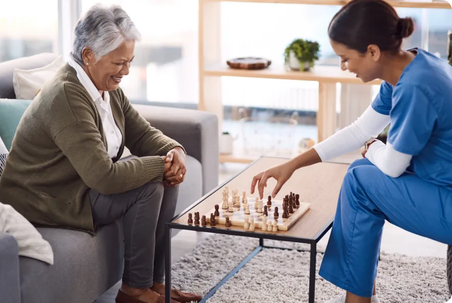 young and adult women playing chess