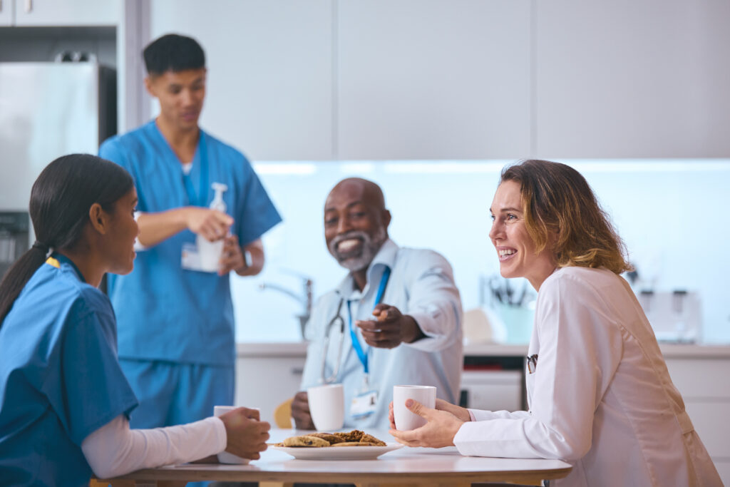 what is the best home care agency to work for in philadelphia Multi-cultural medical team taking a coffee break in a hospital break room, smiling and engaging in a friendly conversation. Doctors and nurses in scrubs and lab coats are enjoying their break with coffee and cookies.