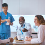 what is the best home care agency to work for in philadelphia Multi-cultural medical team taking a coffee break in a hospital break room, smiling and engaging in a friendly conversation. Doctors and nurses in scrubs and lab coats are enjoying their break with coffee and cookies.